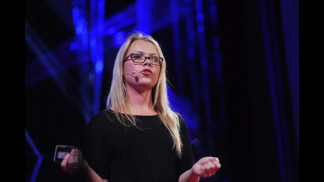 Lexi Mills CEO of Shift6 on stage speaking at a conference